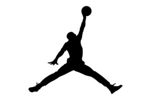 jump silhouette - man with legs outstretched with basketball held above head